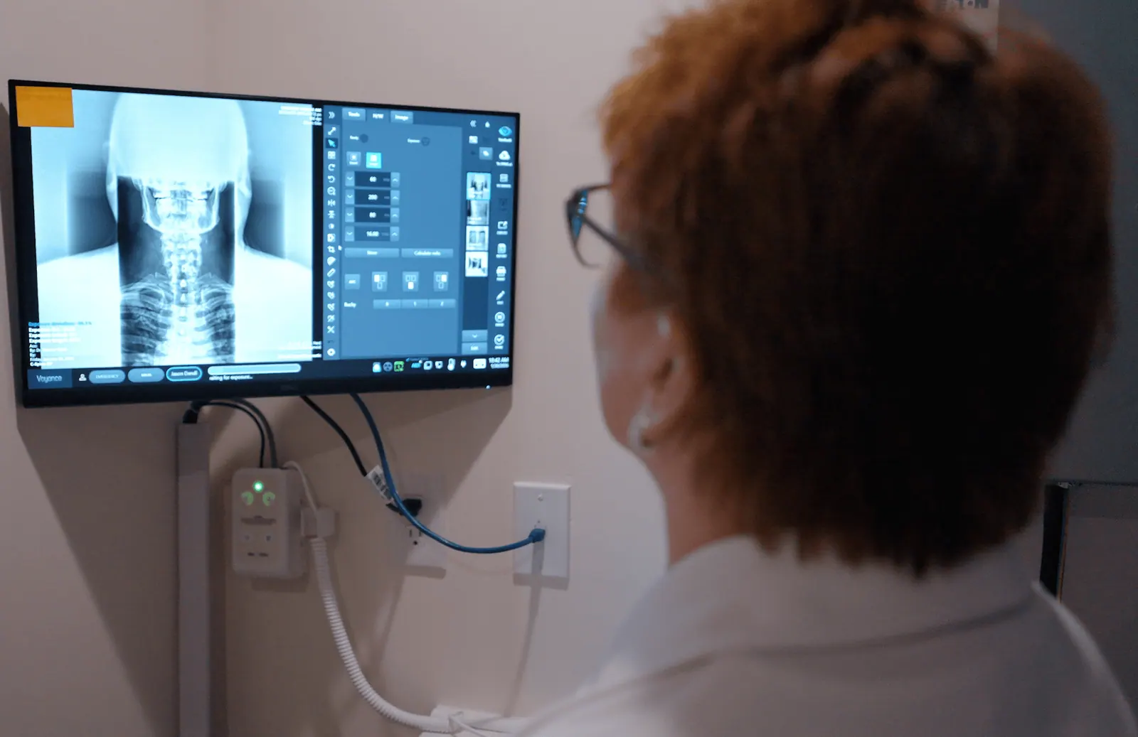 Dr. Trish Wolff reviewing a digital neck X-ray on screen