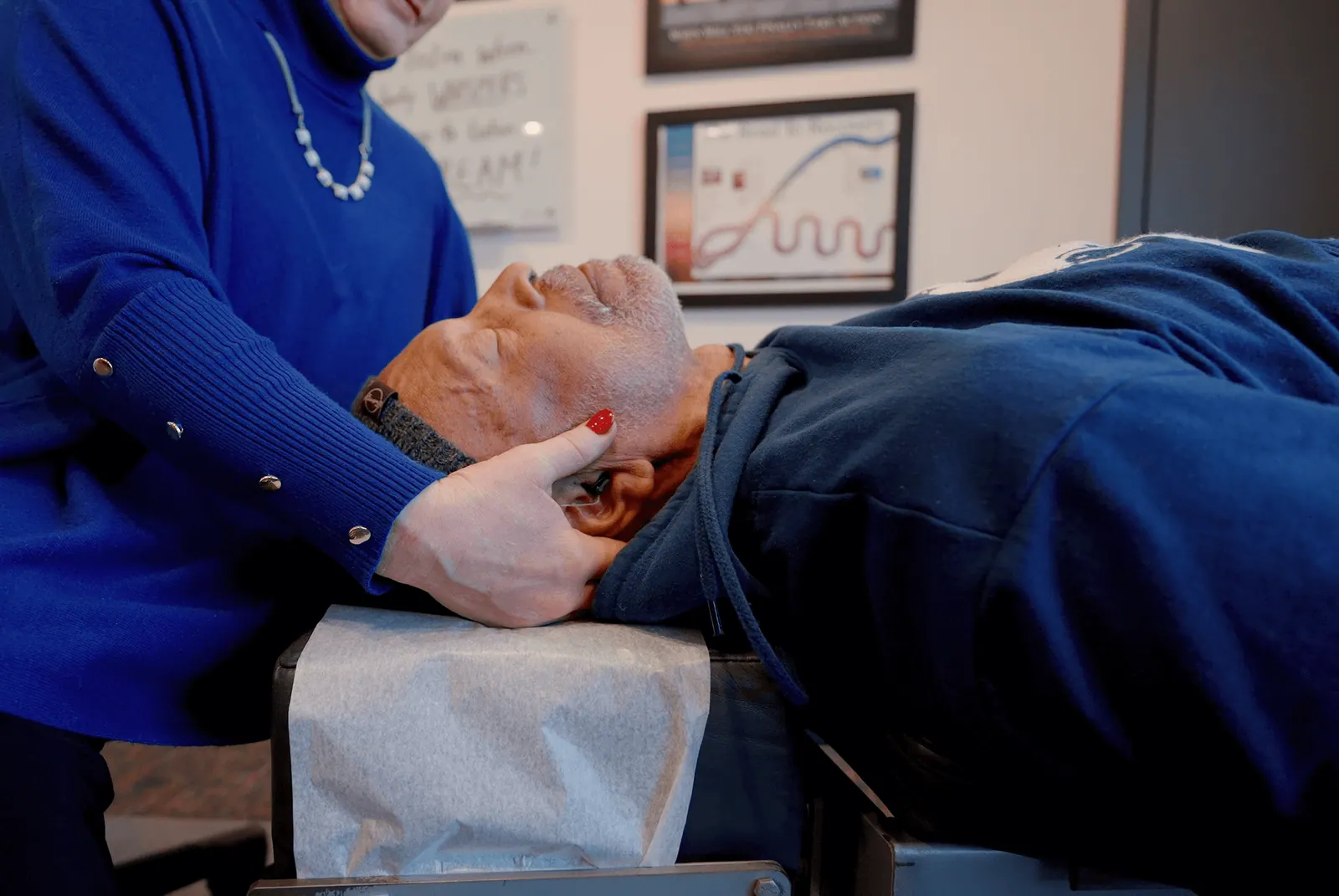 Dr. Trish Wolff adjusting a patient's neck