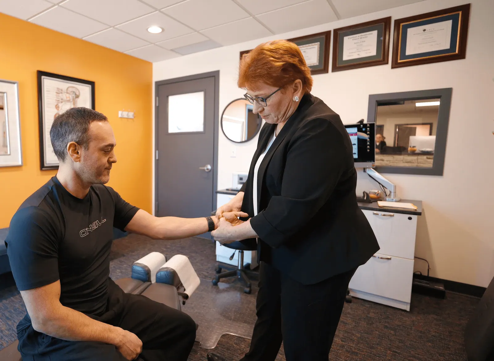 Dr. Trish Wolff treating a patient's wrist