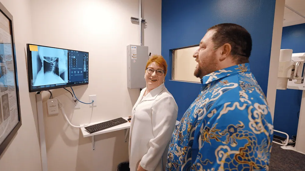 Dr. Trish Wolff discussing X-ray results with a patient