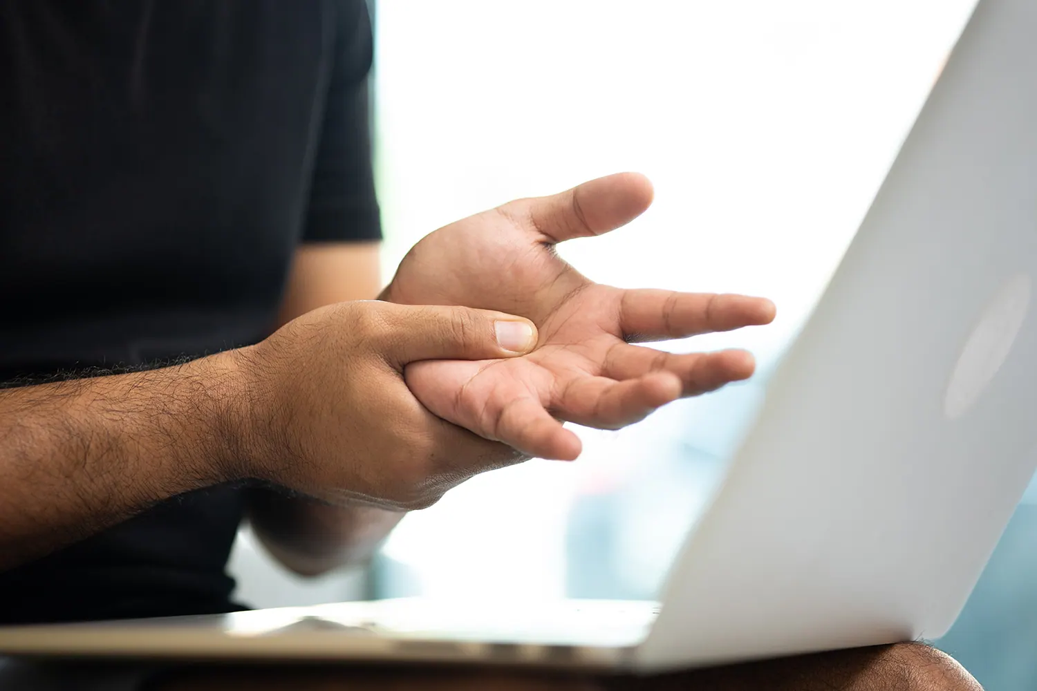 man working in laptop feel sudden pain due to carpal tunnel